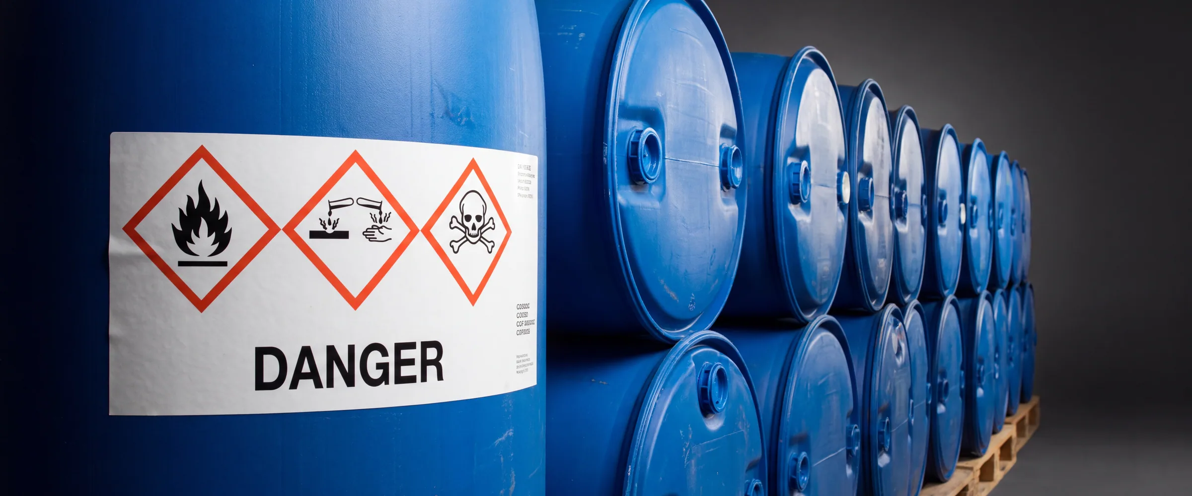 CLP hazard labels with diamond pictograms on chemical drums