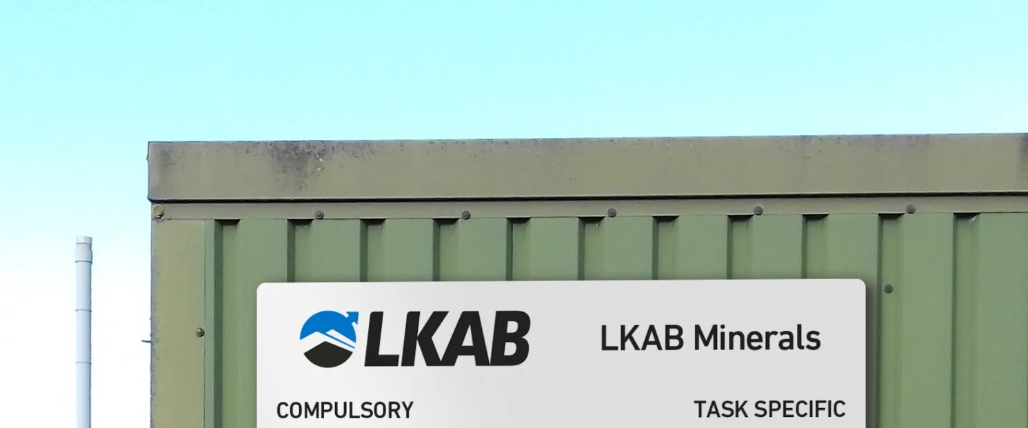 A site PPE requirement board installed on a UK industrial site